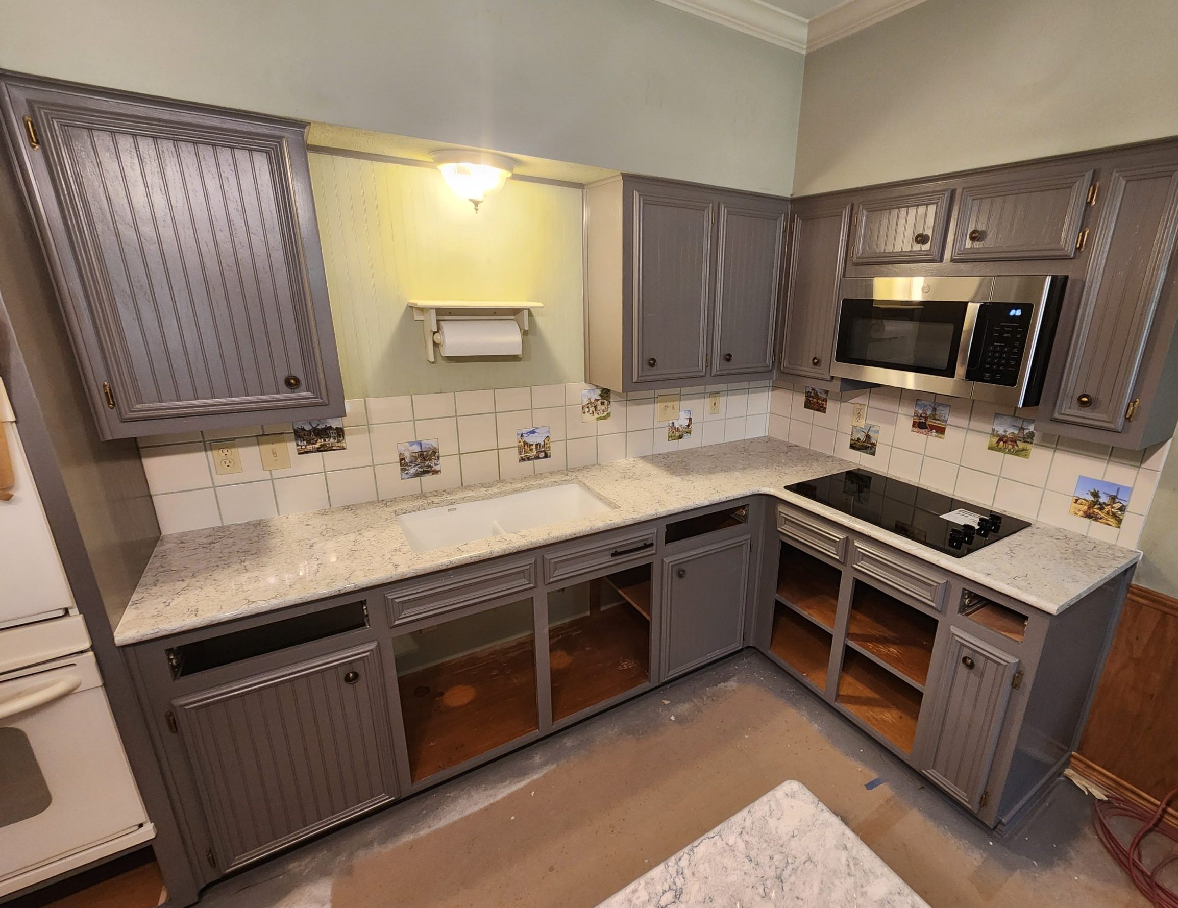 modern kitchen remodel layout with grey cabinets and stone countertops
