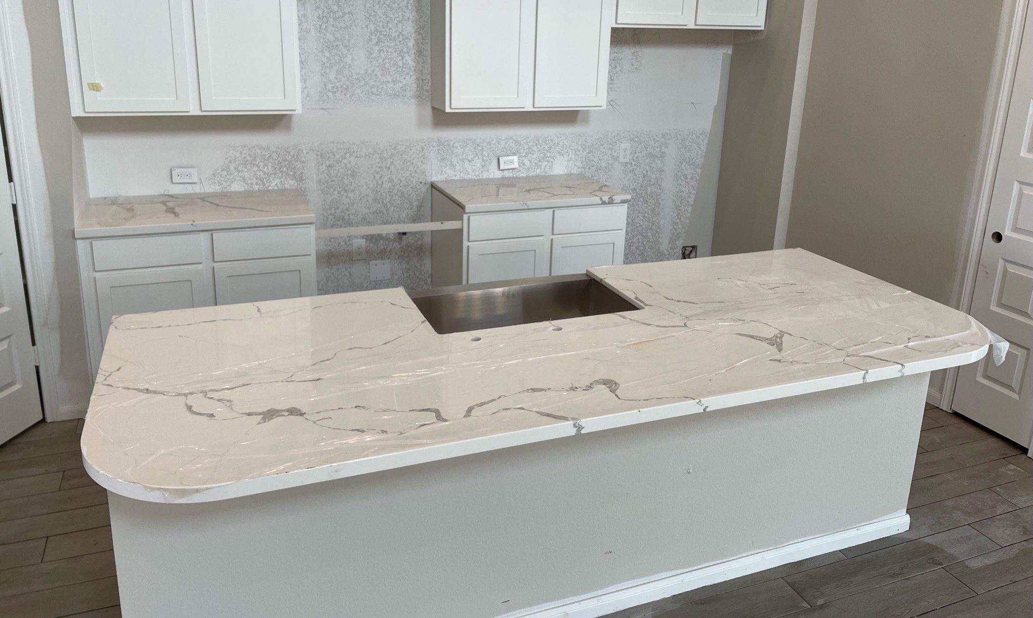 kitchen remodel with rounded island made of stone