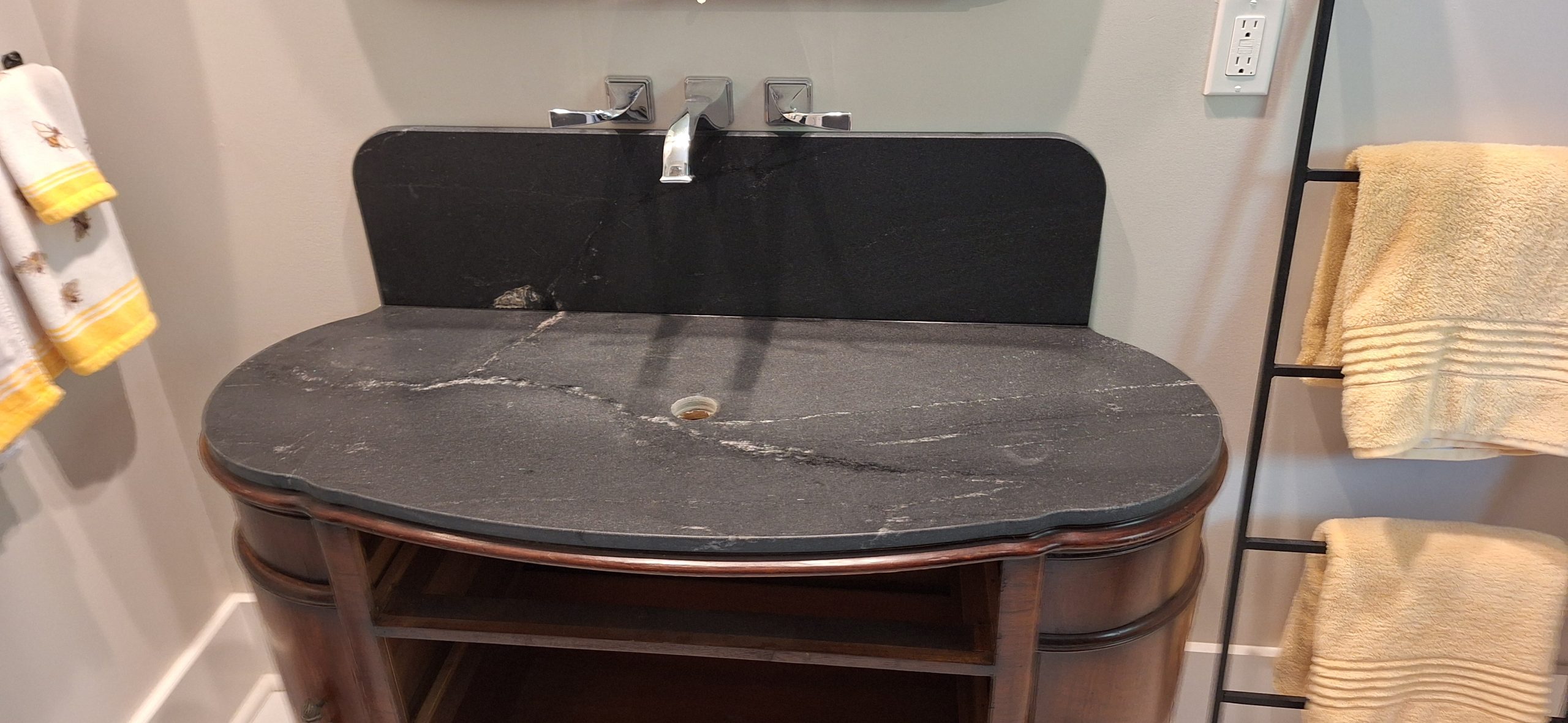 modern black granite countertop installed on bathroom sink