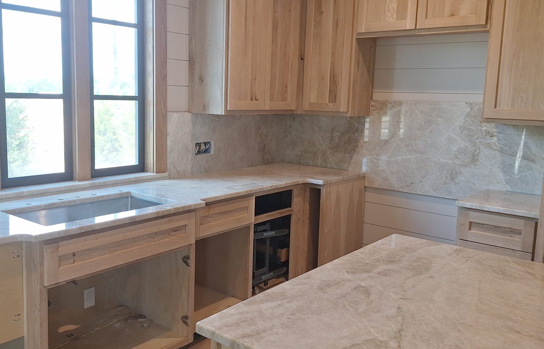 neutral colored kitchen remodel with quartz countertops and matching backsplash