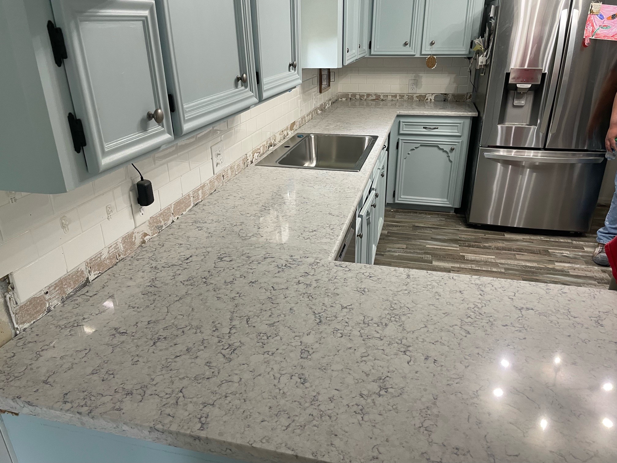 kitchen remodel with gray cabinets and quartz countertops