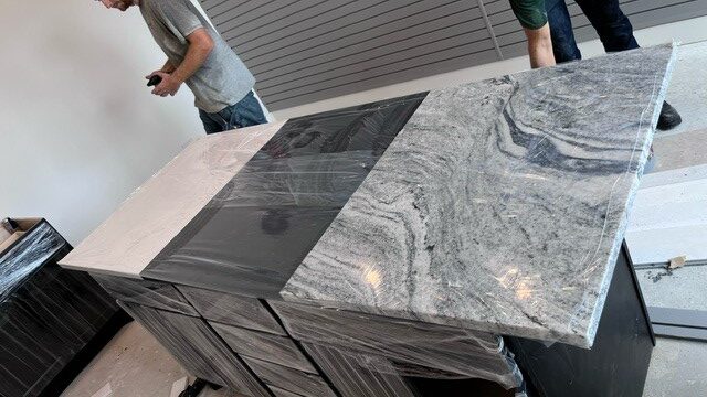 grey marbled quartz island with stove top