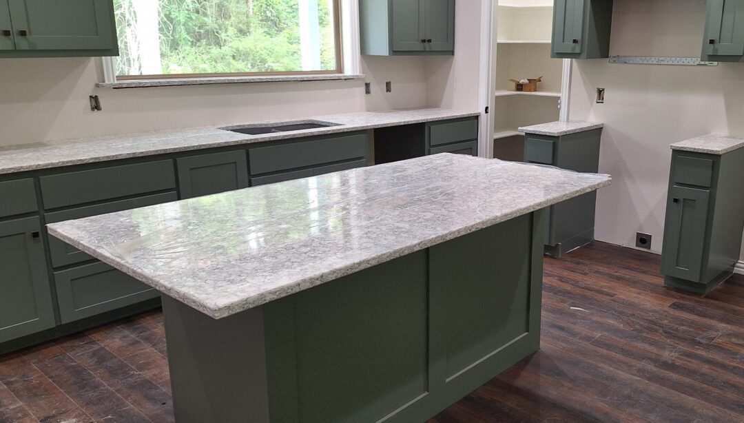 modern kitchen with quartz countertop island and green cabinets