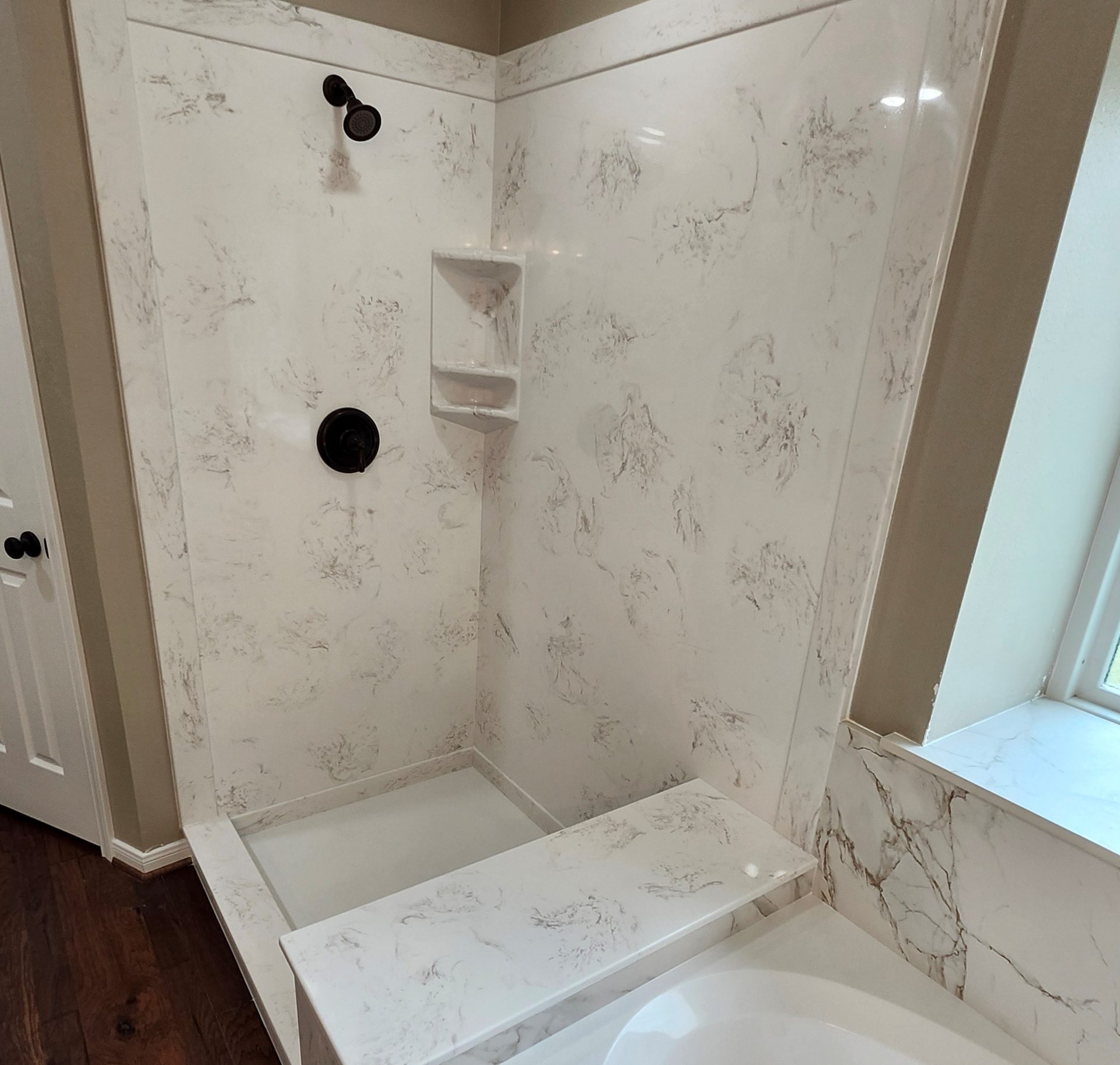 Bathroom shower and tub remodel with cast polymer cultured marble walls.