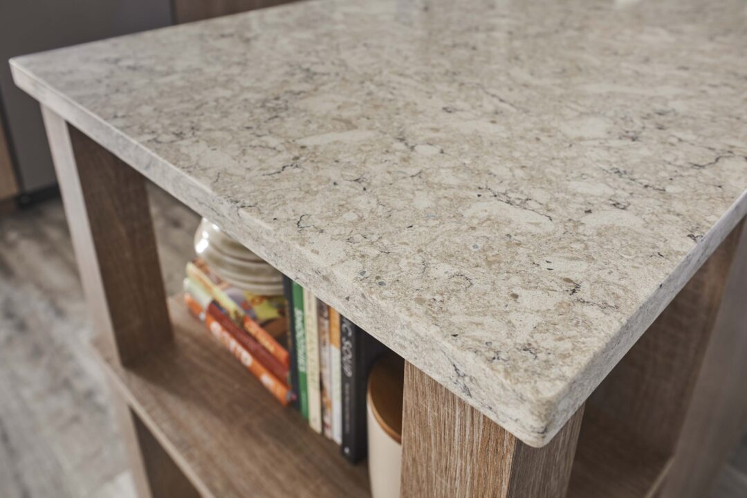 Close up of an eased edge quartz countertop in a neutral colored kitchen.