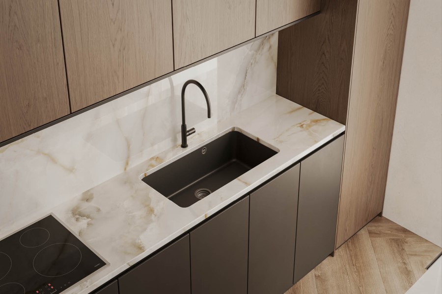 A warm neutral toned backsplash and countertop installed in a modern kitchen with brown cabinets. 